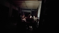 Des Tunisiens jouent aux cartes à la lumière de leurs smartphones dans un café, lors d'une coupure d'électricité dans un quartier d'Ariana, à Tunis, le 14 juillet 2026.