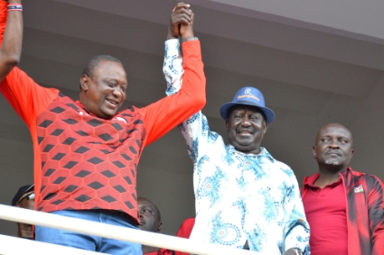L'ancien opposant kenyan Raila Odinga (chapeau bleu) en compagnie du président Uhuru Kenyatta (en rouge à sa droite) à la tribune du Moi International Sports Centre, le 8 mai 2022.