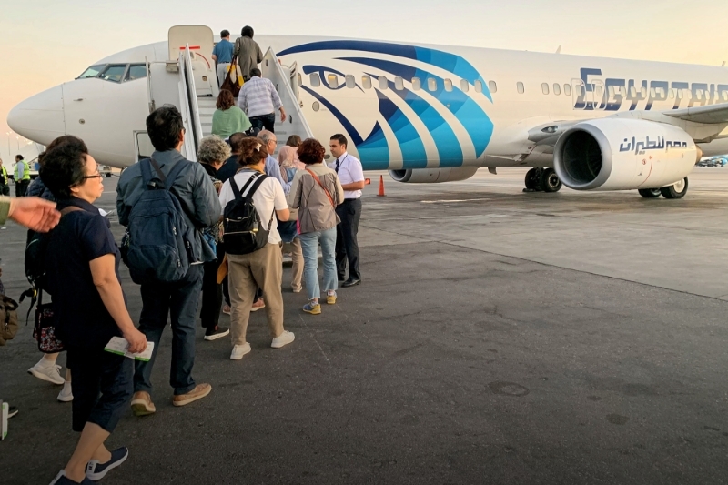 Des touristes embarquent dans un avion au Caire, en octobre 2019.